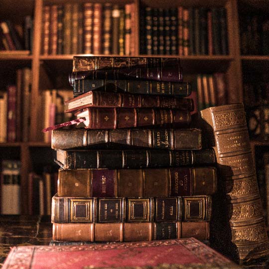 A stack of old books in a library, sources of inspiration