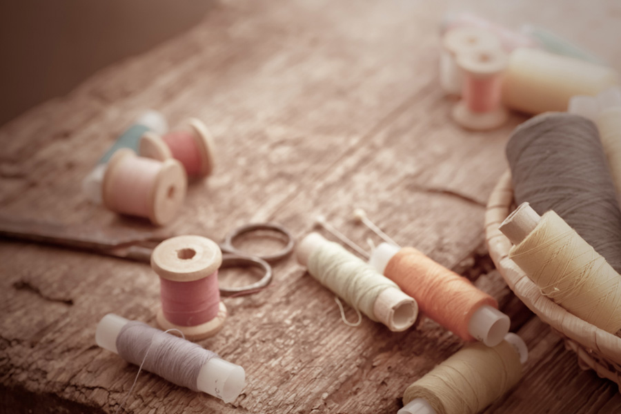 featured image - spools of thread on a rustic table